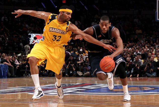 NEW YORK - MARCH 12: Greg Monroe #10 of the Georgetown Hoyas dribbles the ball as Lazar Hayward #32 of the Marquette Golden Eagles reaches in during the semifinal of the 2010 Big East Tournament at Madison Square Garden on March 12, 2010 in New York City.  (Photo by Jim McIsaac/Getty Images)