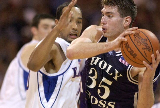 14 Mar 2002: Tim Szatko #35 of Holy Cross moves against the defense of Drew Gooden #0 of Kansas during the first round of the NCAA Basketball Tournament at the Edward Jones Dome in St. Louis, Missouri. Kansas defeated Holy Cross 68-59 DIGITAL IMAGE. Mandatory Credit: Elsa  /Getty Images