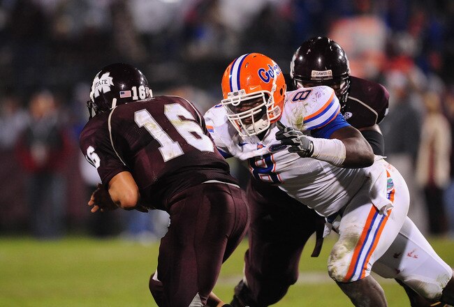 STARKVILLE, MS - OCTOBER 24:  Quarterback Tyson Lee # 16 of the Mississippi State Bulldogs is tackled by defensive end Carlos Dunlap # 8 of the Florida Gators, at Davis Wade Stadium on  October 24, 2009 in Starkville, Mississippi  (Photo by Rick Dole/Getty Images)