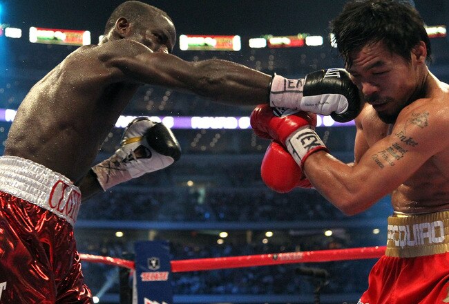 ARLINGTON, TX - MARCH 13:  (L-R) Joshua Clottey of Ghana connects with a right to the face of Manny Pacquiao of the Philippines during the WBO welterweight title fight at Cowboys Stadium on March 13, 2010 in Arlington, Texas. (Photo by Jed Jacobsohn/Getty Images)