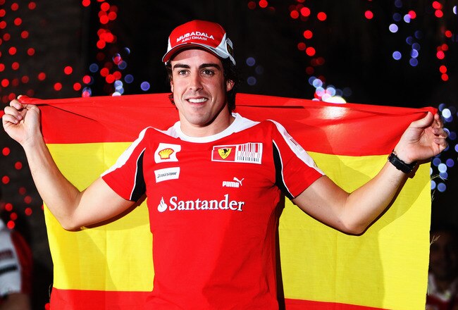 SAKIR, BAHRAIN - MARCH 14:  Fernando Alonso of Spain and Ferrari celebrates in the paddock with team mates after winning the Bahrain Formula One Grand Prix at the Bahrain International Circuit on March 14, 2010 in Sakir, Bahrain.  (Photo by Mark Thompson/Getty Images)