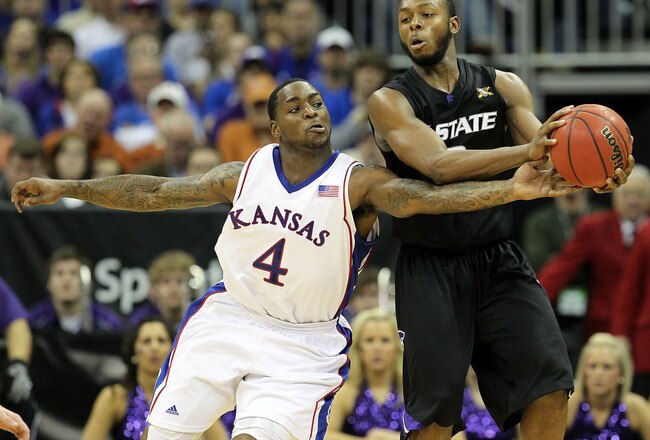 KANSAS CITY, MO - MARCH 13: Sherron Collins #4 of the Kansas Jayhawks attempts a steal on Jacob Pullen #0 of the Kansas State Wildcats during the finals of the 2010 Phillips 66 Big 12 Men's Basketball Tournament on March 13, 2010 at the Sprint Center in Kansas City, Missouri.  (Photo by Jamie Squire/Getty Images)