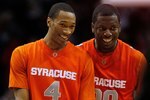 ROSEMONT, IL - JANUARY 30: Wes Johnson #4 and Rick Jackson #00 of the Syracuse Orange smile as they walk off the court following a close win over the DePaul Blue Demons at the Allstate Arena on January 30, 2010 in Rosemont, Illinois. Syracuse defeated DePaul 59-57. (Photo by Jonathan Daniel/Getty Images)