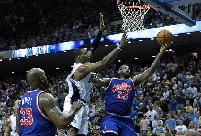 ORLANDO, FL - FEBRUARY 21:  LeBron James #23 of the Cleveland Cavaliers attempts a shot over Dwight Howard #12 of the Orlando Magic at Amway Arena on February 21, 2010 in Orlando, Florida. NOTE TO USER: User expressly acknowledges and agrees that, by downloading and/or using this Photograph, user is consenting to the terms and conditions of the Getty Images License Agreement.  (Photo by Sam Greenwood/Getty Images)