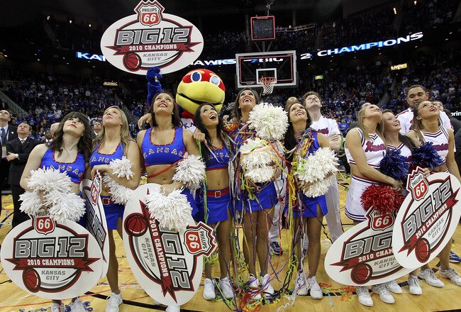 KANSAS CITY, MO - MARCH 13:  Kansas Jayhawks mascot and cheerleaders watch highlights on the videoboard after the Jayhawks defeated the Kansas State Wildcats to win the 2010 Phillips 66 Big 12 Men's Basketball Championship on March 13, 2010 at the Sprint Center in Kansas City, Missouri.  (Photo by Jamie Squire/Getty Images)