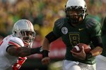 PASADENA, CA - JANUARY 01:  Quarterback Jeremiah Masoli #8 of the Oregon Ducks runs with the ball against the Ohio State Buckeyes in the 96th Rose Bowl game on January 1, 2010 in Pasadena, California.  (Photo by Stephen Dunn/Getty Images)