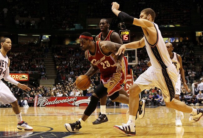 EAST RUTHERFORD, NJ - MARCH 03:  LeBron James #23 of the Cleveland Cavaliers controls the ball against the New Jersey Nets at the Izod Center on March 3, 2010 in East Rutherford, New Jersey.NOTE TO USER: User expressly acknowledges and agrees that, by downloading and or using this photograph, User is consenting to the terms and conditions of the Getty Images License Agreement.  (Photo by Jim McIsaac/Getty Images)