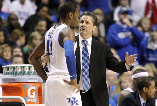 NASHVILLE, TN - MARCH 14:  Head coach John Calipari (R) of the Kentucky Wildcats talks with John Wall #11 against the Mississippi State Bulldogs during the final of the SEC Men's Basketball Tournament at the Bridgestone Arena on March 14, 2010 in Nashville, Tennessee. Kentucky won 75-74 in overtime.  (Photo by Andy Lyons/Getty Images)