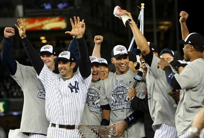 NEW YORK - NOVEMBER 04:  (L-R) A.J. Burnett #34, Jorge Posada #20, Derek Jeter #2 and Mariano Rivera #42 of the New York Yankees celebrate with the trophy after their 7-3 win against the Philadelphia Phillies in Game Six of the 2009 MLB World Series at Yankee Stadium on November 4, 2009 in the Bronx borough of New York City.  (Photo by Nick Laham/Getty Images)