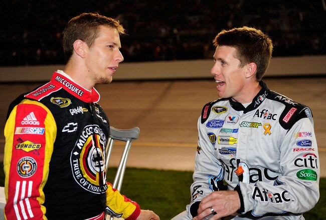 RICHMOND, VA - SEPTEMBER 12:  Brad Keselowski (L), driver of the #09 Miccosukee Gaming Chevrolet, talks with Carl Edwards (R), driver of the #99 Aflac Ford, before the NASCAR Sprint Cup Series Chevy Rock & Roll 400 at Richmond International Raceway on September 12, 2009 in Richmond, Virginia.  (Photo by Rusty Jarrett/Getty Images for NASCAR)