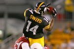 PITTSBURGH - AUGUST 13: Limas Sweed #14 of the Pittsburgh Steelers makes a catch as Karlos Dansby #58 and Bryant McFadden #25 of the Arizona Cardinals make the tackle during a preseason NFL game August 13, 2009 at Heinz Field in Pittsburgh, Pennsylvania.  (Photo by Rick Stewart/Getty Images)