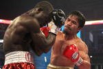 ARLINGTON, TX - MARCH 13:  (R-L) Manny Pacquiao of the Philippines throws a right to the head of Joshua Clottey of Ghana during the WBO welterweight title fight at Cowboys Stadium on March 13, 2010 in Arlington, Texas. Pacquiao defeated Clottey by unanimous decision.  (Photo by Jed Jacobsohn/Getty Images)
