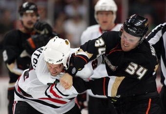 ANAHEIM, CA - MARCH 17:  James Wisniewski #34 of the Anaheim Ducks punches Nick Boynton #24 of the Chicago Blackhawks during their fight in the third period of their NHL game at the Honda Center on March 17, 2010 in Anaheim, California. The Ducks defeated the Blackhawks 4-2. (Photo by Victor Decolongon/Getty Images)
