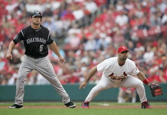 ST. LOUIS - MAY 10:  Albert Pujols #5 of the St. Louis Cardinals overs Matt Holliday #5 of the Colorado Rockies as he leads off base on May 10,2006 at Busch Stadium in St. Louis, Missouri. The St. Louis Cardinals defeated the Colorado Rockies 7-4. (Photo by Elsa/Getty Images)