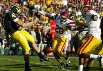 PASADENA, CA - JANUARY 01:  Punter Zoltan Mesko #41 of the Michigan Wolverines punts the ball under pressure from Terrell Thomas #28 and Cary Harris #7 of the USC Trojans during the Rose Bowl game on January 1, 2007 at the Rose Bowl in Pasadena, California. The Trojans defeated the Wolverines 32-18.  (Photo by Christian Petersen/Getty Images) 