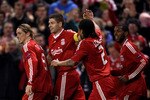 LIVERPOOL, ENGLAND - MARCH 18:  Steven Gerrard of Liverpool celebrates scoring the opening goal from the penalty spot with his team mates during the UEFA Europa League Round of 16, second leg match at Anfield on March 18, 2010 in Liverpool, England.  (Photo by Alex Livesey/Getty Images)