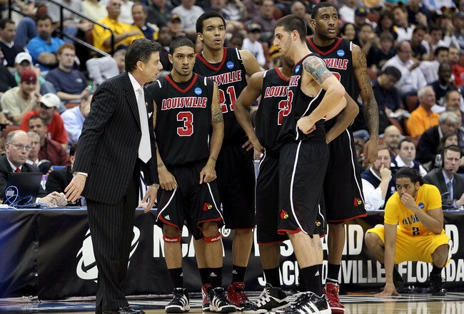 JACKSONVILLE, FL - MARCH 19: Rick Pitino the Head Coach of the Louisville Cardinals talks to his team in the game against the California Golden Bears during the first round of the 2010 NCAA men's basketball tournament at Jacksonville Veteran's Memorial Arena on March 19, 2010 in Jacksonville, Florida. (Photo by Andy Lyons/Getty Images)