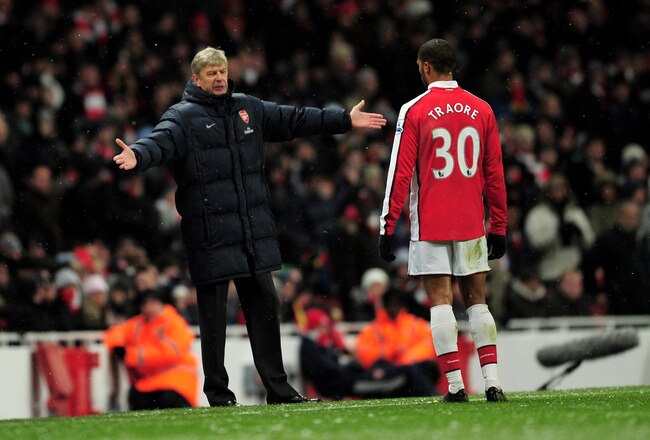 LONDON, ENGLAND - JANUARY 09:  Manager of Arsenal Arsene Wenger speaks to Armand Traore of Arsenal during the Barclays Premier League match between Arsenal and Everton at Emirates Stadium on January 9, 2010 in London, England.  (Photo by Shaun Botterill/Getty Images)