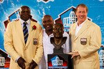 CANTON, OH - AUGUST 8: Bruce Smith looks on with former Buffalo Bills teammates Thurman Thomas (center) and Jim Kelly following his induction into the Pro Football Hall of Fame during the 2009 enshrinement ceremony at Fawcett Stadium on August 8, 2009 in Canton, Ohio. (Photo by Joe Robbins/Getty Images)