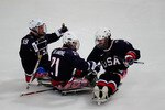 VANCOUVER, BC - MARCH 16:  Alexi Salamone #21 of the United States celebrates his goal with teammates Taylor Lipsett #7 and Taylor Chace #19 during the Ice Sledge Hockey Preliminary Round Group A Game on day five of the 2010 Vancouver Winter Paralympic Games at UBC Thunderbird Arena on March 16, 2010 in Vancouver, Canada.   The United States defeated Japan 6-0. (Photo by Jamie McDonald/Getty Images)