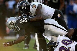 OAKLAND, CA - JANUARY 3: Terrell Suggs #55 of the Baltimore Ravens tackles JaMarcus Russell #2 of the Oakland Raiders during an NFL game at Oakland-Alameda County Coliseum on January 3, 2010 in Oakland, California. (Photo by Jed Jacobsohn/Getty Images)