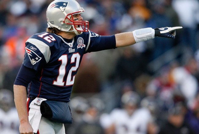 FOXBORO, MA - JANUARY 10:  Tom Brady #12 of the New England Patriots gestures as he lines up in the shotgun formation against the Baltimore Ravens during the 2010 AFC wild-card playoff game at Gillette Stadium on January 10, 2010 in Foxboro, Massachusetts.  (Photo by Elsa/Getty Images)