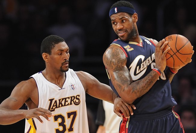 LOS ANGELES, CA - DECEMBER 25:  LeBron James #23 of the Cleveland Cavaliers drives against Ron Artest #37 of the Los Angeles Lakers at Staples Center on December 25, 2009 in Los Angeles, California. NOTE TO USER: User expressly acknowledges and agrees that, by downloading and or using this photograph, User is consenting to the terms and conditions of the Getty Images License Agreement.  (Photo by Lisa Blumenfeld/Getty Images)