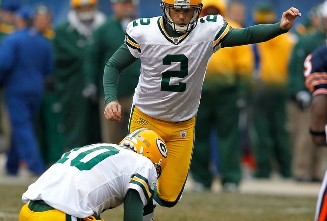 CHICAGO - DECEMBER 13: Mason Crosby #2 of the Green Bay Packers kicks an extra point out of the hold of Matt Flynn #10 against the Chicago Bears at Soldier Field on December 13, 2009 in Chicago, Illinois. The Packers defeated the Bears 21-14. (Photo by Jonathan Daniel/Getty Images)