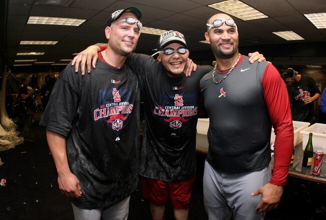 DENVER - SEPTEMBER 26:  (L-R) Matt Holliday, Yadier Molina and Albert Pujols of the St. Louis Cardinals celebrate clinching the National League Central Division after defeating the Colorado Rockies at Coors Field on September 26, 2009 in Denver, Colorado. The Cardinals defeated the Rockies 6-3.  (Photo by Doug Pensinger/Getty Images)