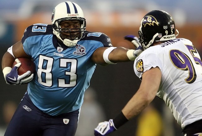 NASHVILLE, TN - JANUARY 10:  Tight end Alge Crumpler #83 of the Tennessee Titans uses a stiff arm on linebacker Jarret Johnson #95 of the Baltimore Ravens in the first quarter during the AFC Divisional Playoff Game on January 10, 2009 at LP Field in Nashville, Tennessee.  (Photo by Andy Lyons/Getty Images)