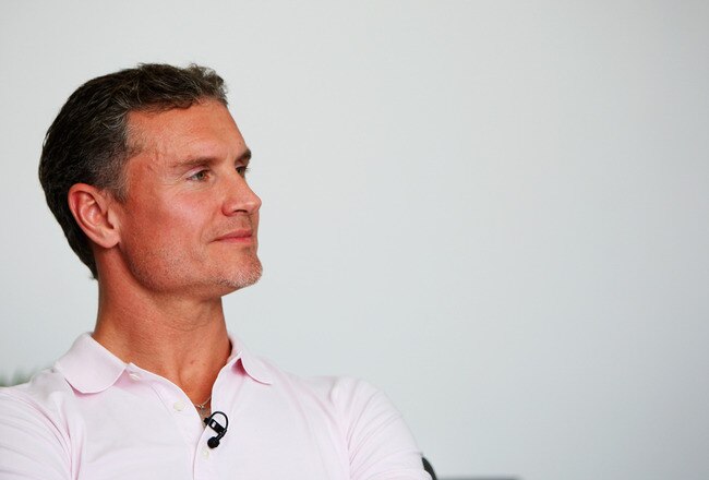 ABU DHABI, UNITED ARAB EMIRATES - OCTOBER 29:  David Coulthard interviews Red Bull Racing drivers Sebastian Vettel of Germany and Mark Webber of Australia during previews to the Abu Dhabi Formula One Grand Prix at the Yas Marina Circuit on October 29, 2009 in Abu Dhabi, United Arab Emirates.  (Photo by Mark Thompson/Getty Images)