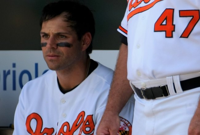 BALTIMORE - JULY 30:  Brian Roberts #1 sits in the dugout next to manager Dave Trembley #47 of the Baltimore Orioles as they facet the Kansas City Royals during MLB action at Oriole Park at Camden Yards on July 30, 2009 in Baltimore, Maryland. The Orioles defeated the Royals 7-3.  (Photo by Doug Pensinger/Getty Images)
