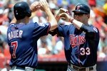ANAHEIM, CA - JULY 26:  Justin Morneau #33 of the Minnesota Twins celebrates his two-run home run with teammate Joe Mauer #7 during the first inning against the Los Angeles Angels of Anaheim at Angels Stadium on July 26, 2009 in Anaheim, California. (Photo by Harry How/Getty Images)