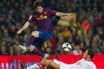 BARCELONA, SPAIN - MARCH 24: Lionel Messi (L) of FC Barcelona competes for the ball with Krisztian Vad�cz of Osasuna during the La Liga match between Barcelona and Osasuna at the Camp Nou Stadium on March 24, 2010 in Barcelona, Spain.  (Photo by Manuel Queimadelos Alonso/Getty Images)