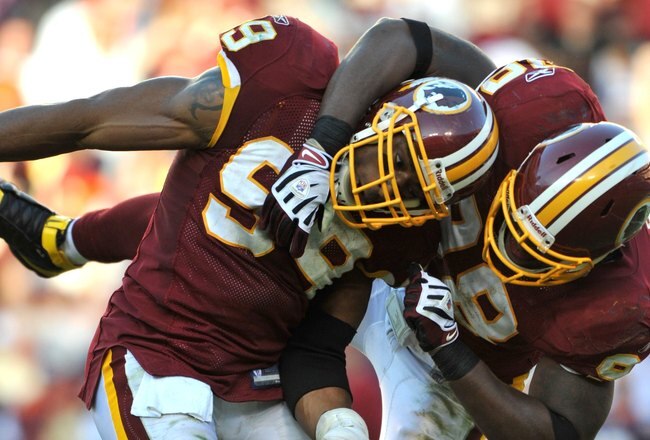 LANDOVER, MD - NOVEMBER 15:  Andre Carter #99 of the Washington Redskins celebrates a play with Brian Orakpo #98 during   the game against the Denver Broncos at FedExField on November 15, 2009 in Landover, Maryland. The Redskins won 27-17. (Photo by Larry French/Getty Images)