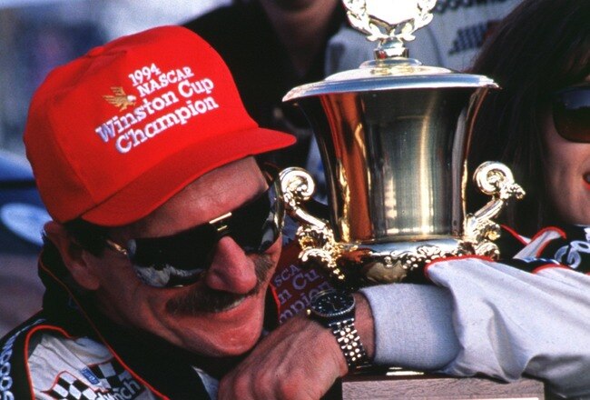 ROCKINGHAM, NC - OCTOBER 23:  Dale Earnhardt driver of the #3 GM Goodwrench Cheverolet poses with the NASCAR Winston Cup championship trophy after winning the AC Delco 500 on October 23, 1994 at the North Carolina Motor Speedway in Rockingham, North Carolina. (Photo by Bill Hall/Getty Images)