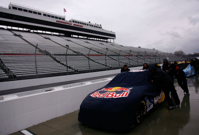MARTINSVILLE, VA - MARCH 26:  Crew members push the #83 Red Bull Toyota off pit road after qualifying was cancelled for the NASCAR Sprint Cup Series Goody's Fast Pain Relief 500 at Martinsville Speedway due to rain on March 26, 2010 in Martinsville, Virginia.  (Photo by Jason Smith/Getty Images for NASCAR)