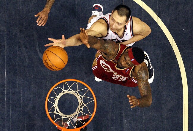 EAST RUTHERFORD, NJ - MARCH 03:  Yi Jianlian #9 of the New Jersey Nets shoots against LeBron James #23 of the Cleveland Cavaliers at the Izod Center on March 3, 2010 in East Rutherford, New Jersey.NOTE TO USER: User expressly acknowledges and agrees that, by downloading and or using this photograph, User is consenting to the terms and conditions of the Getty Images License Agreement.  (Photo by Jim McIsaac/Getty Images)