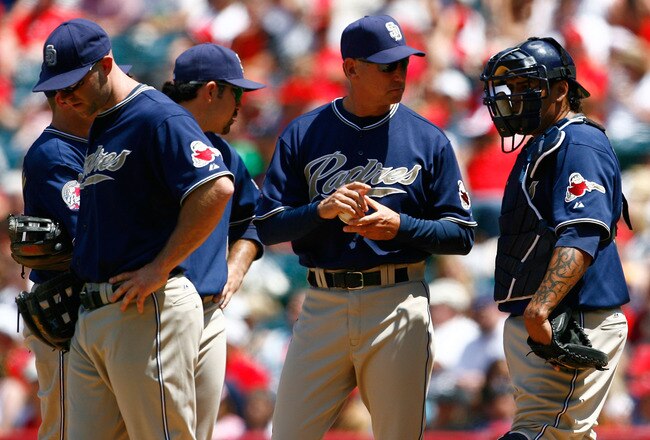 ANAHEIM, CA - JUNE 14:  (L-R) Kevin Kouzmanoff #5, Adrian Gonzalez #23, manager Bud Black and Henry Blanco #28 of the San Diego Padres wait for pitcher Greg Burke (not pictured) to enter the game in the fifth inning against the Los Angeles Angels of Anaheim at Angel Stadium on June 14, 2009 in Anaheim, California. The Angels defeated the Padres 6-0.  (Photo by Jeff Gross/Getty Images)