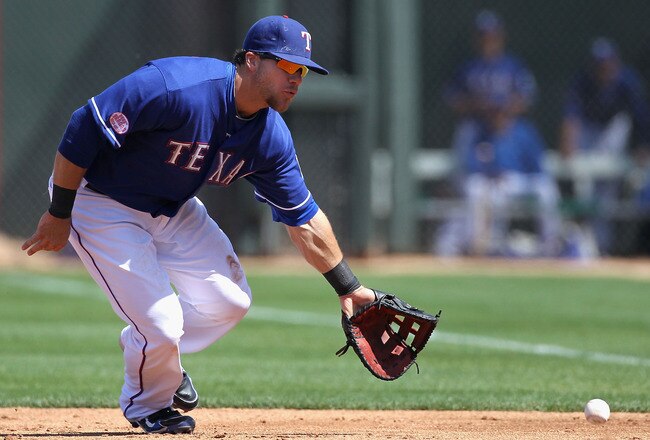 SURPRISE, AZ - MARCH 19:  Infielder Chris Davis #19 of the Texas Rangers fields a ground ball out against the Cleveland Indians during the MLB spring training game at Surprise Stadium on March 19, 2010 in Surprise, Arizona.  The Indians defeated the Rangers 12-2. (Photo by Christian Petersen/Getty Images)