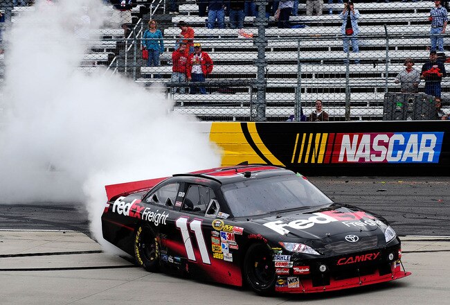 MARTINSVILLE, VA - MARCH 29:  Denny Hamlin, driver of the #11 FedEx Express performs a burnout after winning the NASCAR Sprint Cup Series Goody's Fast Pain Relief 500 at Martinsville Speedway on March 29, 2010 in Martinsville, Virginia.  (Photo by Rusty Jarrett/Getty Images for NASCAR)