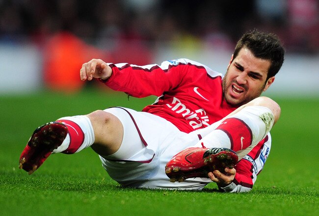LONDON, ENGLAND - MARCH 20:  Cesc Fábregas of Arsenal is knocked to the ground during the Barclays Premier League match between Arsenal and West Ham United at Emirates Stadium on March 20, 2010 in London, England.  (Photo by Mike Hewitt/Getty Images)