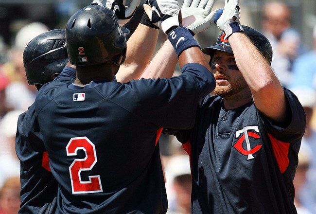 JUPITER, FL - MARCH 15:  Right fielder Jason Kubel #16 of the Minnesota Twins is congratulated by teammates Nick Punto #8 and Denard Span #2 after his three-run home run against the Florida Marlins at Roger Dean Stadium on March 15, 2010 in Jupiter, Florida. The Marlins defeated the Twins 5-4.  (Photo by Doug Benc/Getty Images)