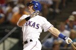 ARLINGTON, TX - JULY 20:  Michael Young #10 of the Texas Rangers watches his solo home run in the sixth inning to tie the Boston Red Sox 2-2 at Rangers Ballpark in Arlington on July 20, 2009 in Arlington, Texas. (Photo by Ronald Martinez/Getty Images)