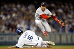 LOS ANGELES, CA - OCTOBER 07:  Julio Lugo #12 of the St. Louis Cardinals turns a double-play in the seventh inning as Andre Ethier #16 of the Los Angeles Dodgers is out at second base on a ball hit by Manny Ramirez #99 in Game One of the NLDS during the 2009 MLB Playoffs at Dodger Stadium on October 7, 2009 in Los Angeles, California.  (Photo by Jeff Gross/Getty Images)
