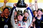 HOMESTEAD, FL - NOVEMBER 22:  Jimmie Johnson, driver of the #48 Lowe's Chevrolet, celebrates with the trophy after winning the NASCAR Sprint Cup Series Championship after finishing in fifth place in the Ford 400 at Homestead-Miami Speedway on November 22, 2009 in Homestead, Florida. Johnson becomes the first driver in the history of NASCAR to win four consecutive championships since the sports inception in 1949.  (Photo by Rusty Jarrett/Getty Images for NASCAR)
