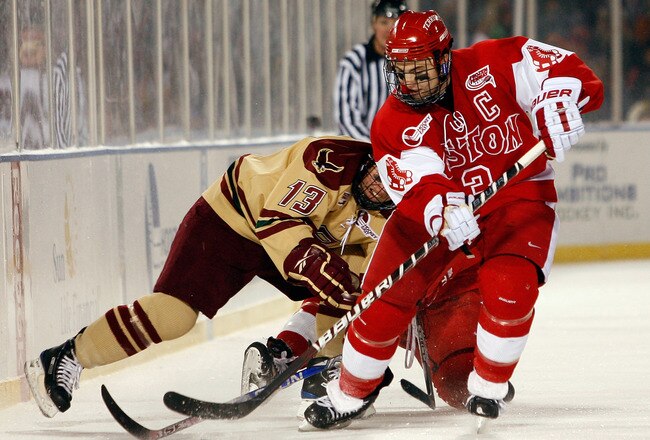 BOSTON - JANUARY 08:  Kevin Shattenkirk #3 of the Boston University Terriers takes the puck from Cam Atkinson #13 of the Boston College Eagles on January 8, 2010 during the Sun Life Frozen Fenway Hockey Game at the Fenway Park in Boston, Massachusetts. The Terriers defeated the Eagles 3-2.  (Photo by Elsa/Getty Images)