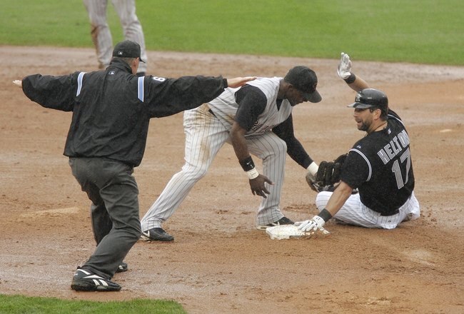 DENVER - JULY 09:  Todd Helton #17 of the Colorado Rockies stretches an RBI single into a double against second baseman Orlando Hudson #1 of the Arizona Diamondbacks in the bottom of the sixth inning on July 9, 2006 at Coors Field in Denver, Colorado. The D-Backs defeated the Rockies 8-5.  (Photo by Brian Bahr/Getty Images)