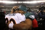 PHILADELPHIA - DECEMBER 27 : Donovan McNabb #5 of the Philadelphia Eagles hugs Brian Dawkins #20 of the Denver Broncos after the game at Lincoln Financial Field on December 27, 2009 in Philadelphia, Pennsylvania. The Broncos were defeated by the Eagles with a score of 27 - 30. (Photo by Jim McIsaac/Getty Images)