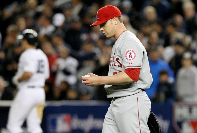 NEW YORK - OCTOBER 25:  Scott Kazmir #22 of the Los Angeles Angels of Anaheim looks on after making an error allowing Melky Cabrera #53 of the New York Yankees to safely reach first base in the bottom of the eighth inning of Game Six of the ALCS during the 2009 MLB Playoffs at Yankee Stadium on October 25, 2009 in the Bronx borough of New York City.  (Photo by Nick Laham/Getty Images)